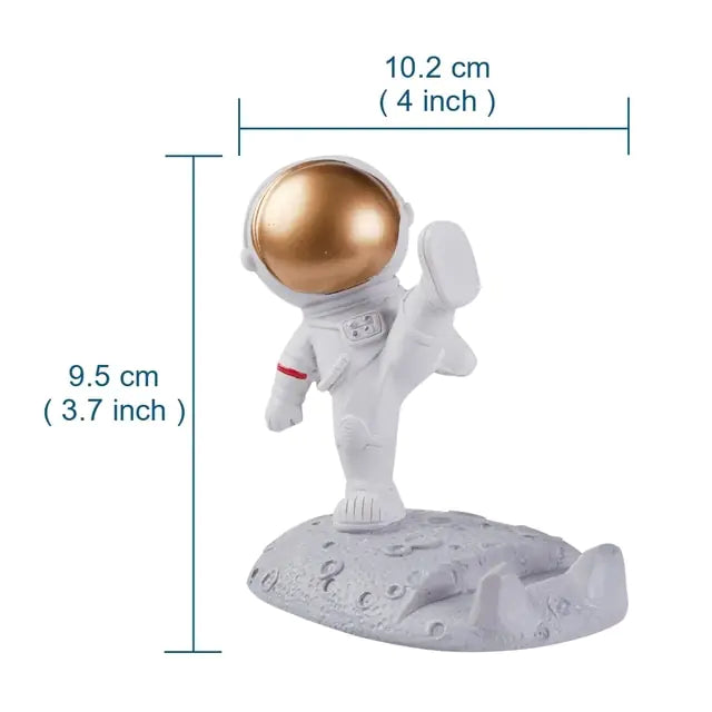 a white and gold astronaut figurine on a white base