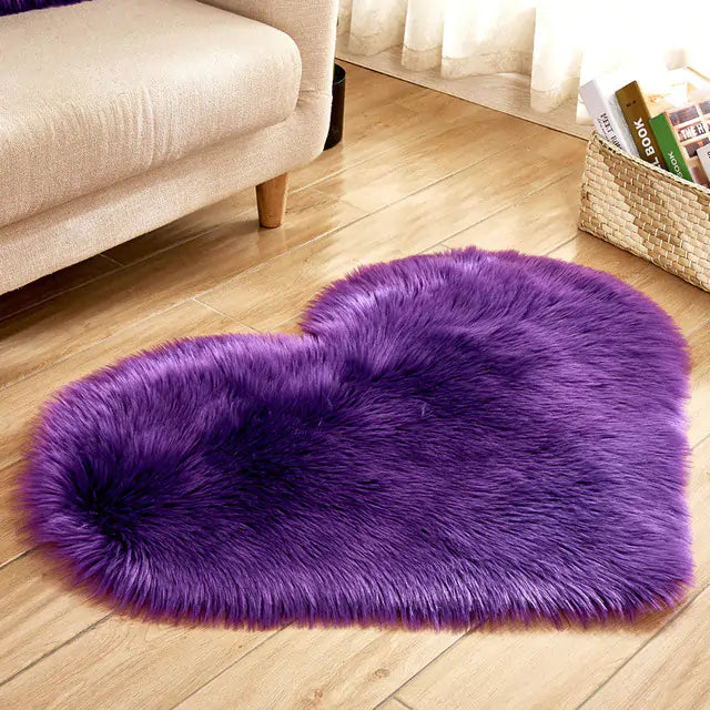 a purple heart shaped rug on a wooden floor