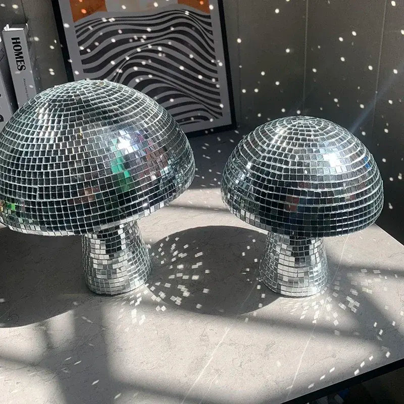 a couple of shiny disco balls sitting on top of a table