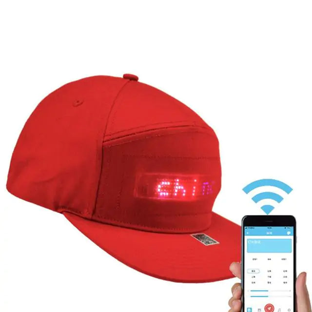 a person holding a cell phone and a red hat