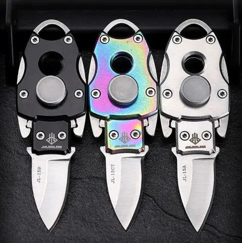 a set of three multicolored knives sitting next to each other
