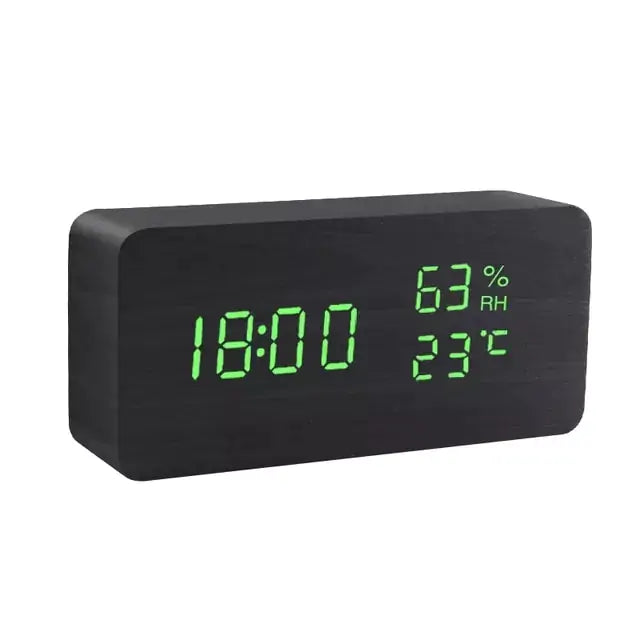 a black clock with green numbers on it