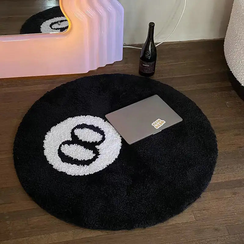 a round rug with a laptop on top of it