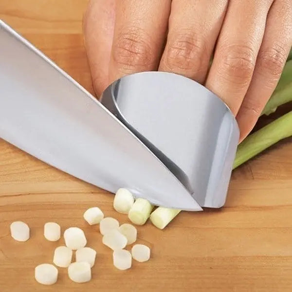 a person cutting onions with a knife on a cutting board