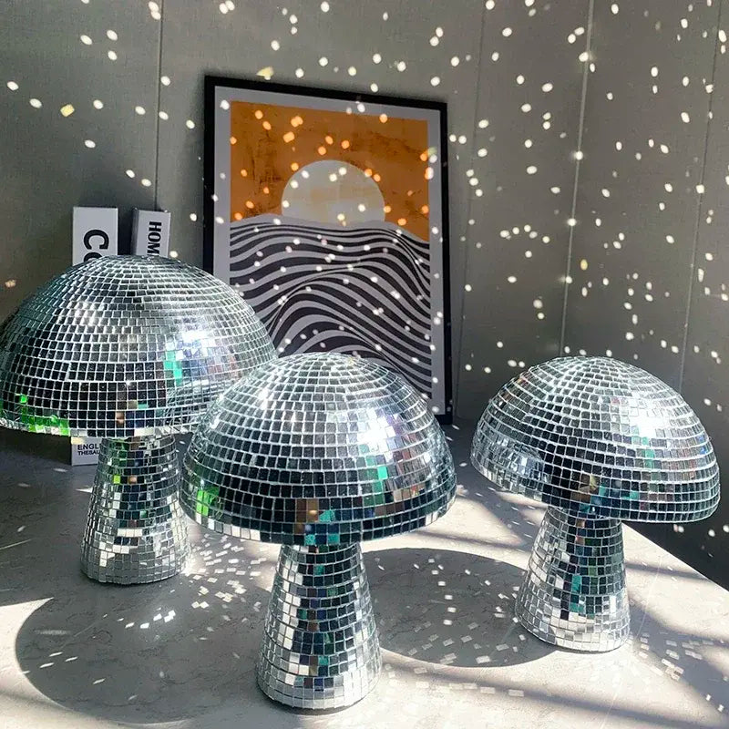 three shiny disco balls sitting on top of a table