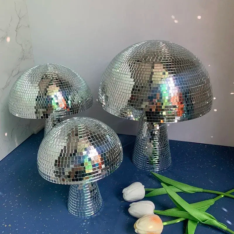 three shiny disco ball lamps sitting on a table