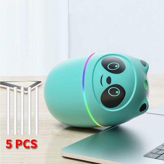 a blue speaker sitting on top of a laptop computer
