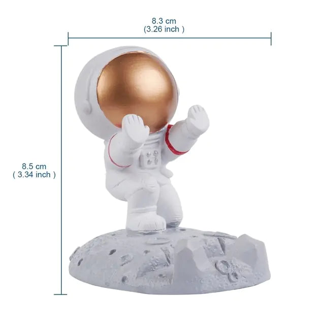 a white and gold astronaut figurine on a white base
