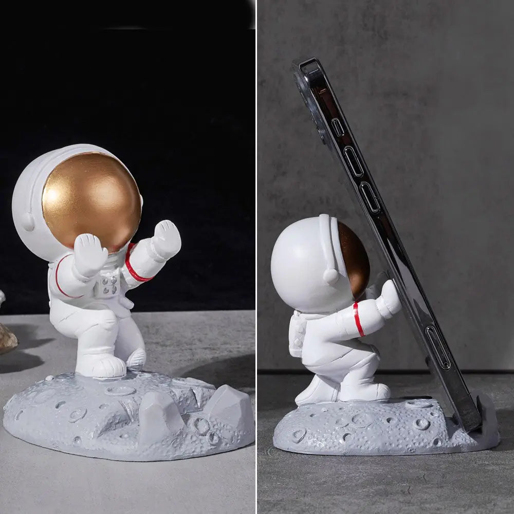 a small statue of an astronaut holding a gold ball