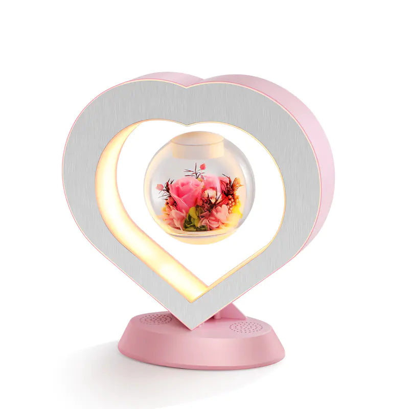 a heart shaped light with flowers inside of it