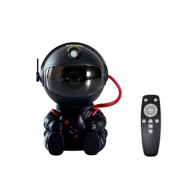 a black robot sitting next to a remote control
