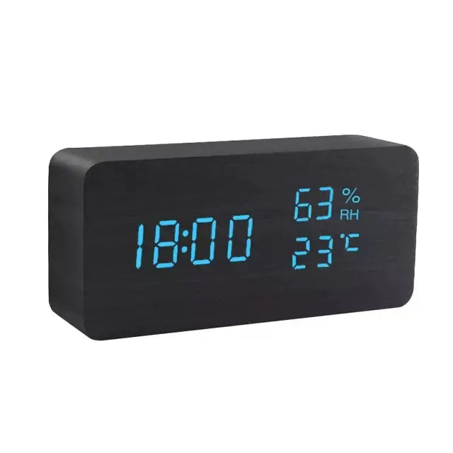 a black clock with blue numbers on it