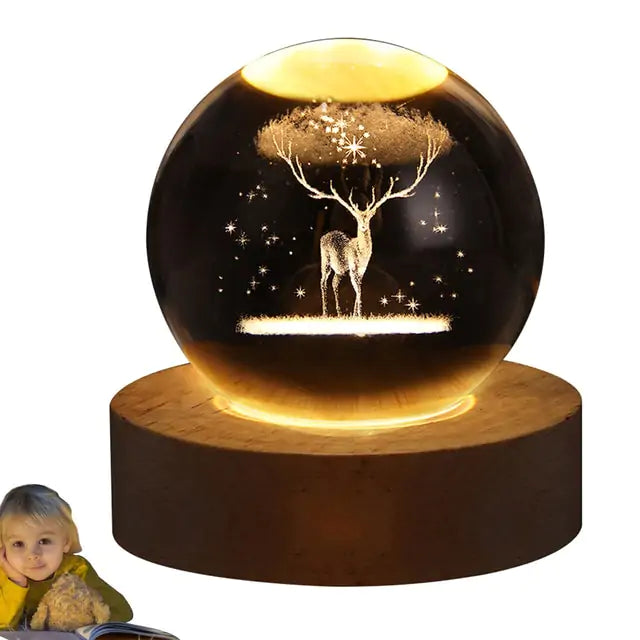 a snow globe with a deer and tree inside