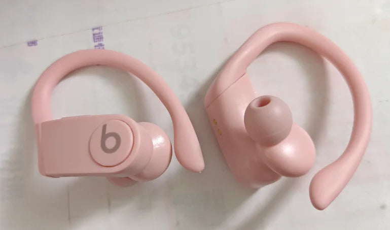 a pair of pink earphones sitting on top of a table