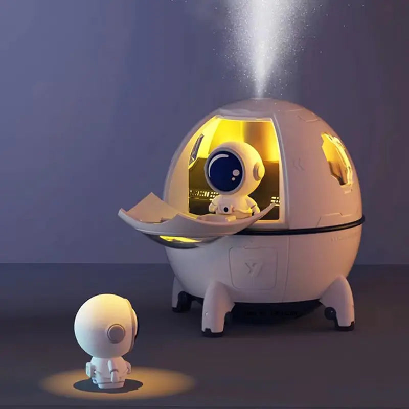 a small white robot next to a small white object