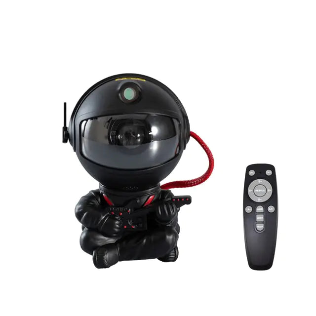 a black robot sitting next to a remote control