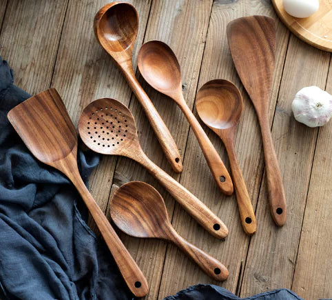 a group of wooden spoons sitting on top of a wooden table