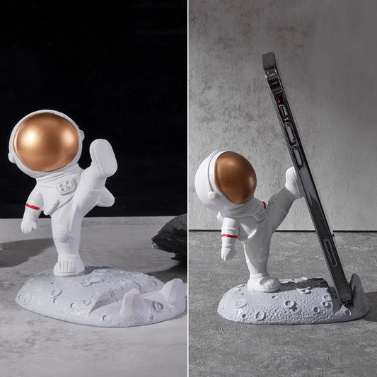 a white and gold astronaut figurine next to a black and white photo of