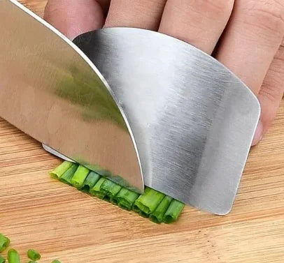 a person cutting celery with a knife on a cutting board