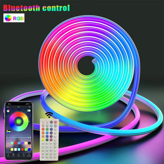 a remote control next to a multicolored led strip