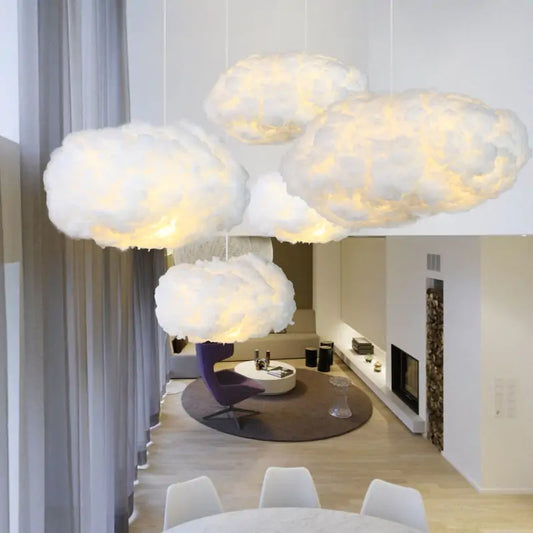 a living room filled with white furniture and clouds hanging from the ceiling