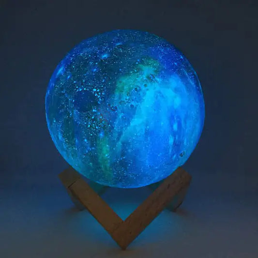 a large blue ball sitting on top of a wooden stand