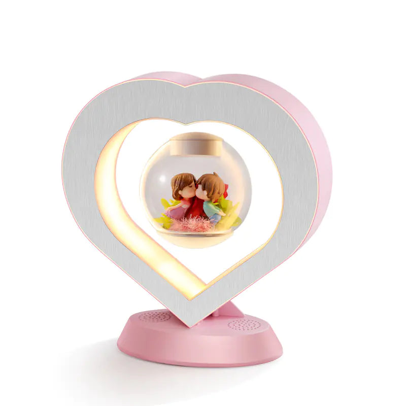 a heart shaped light with a picture of a couple inside of it