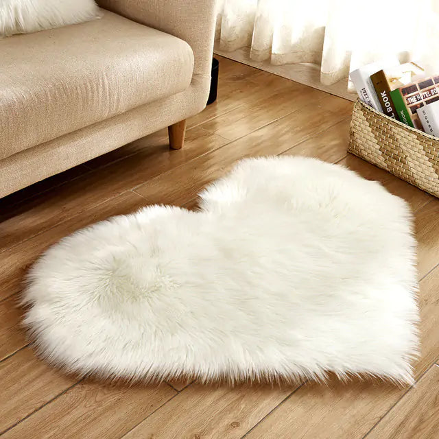 a white heart shaped rug on a wooden floor