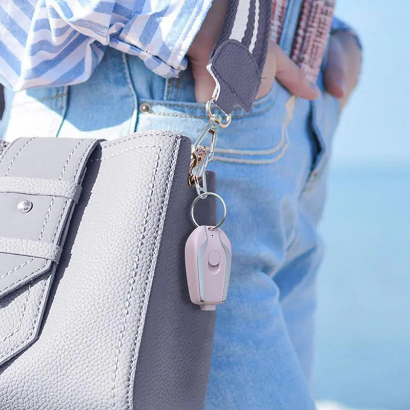 a person holding a purse and a cell phone