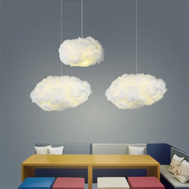 a living room with a couch, table and clouds hanging from the ceiling