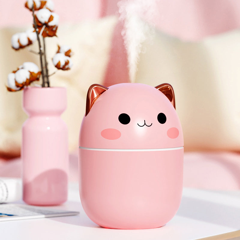 a pink cat humider sitting on top of a table