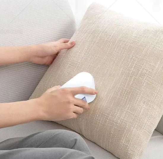 a woman is sitting on a couch with a remote control in her hand