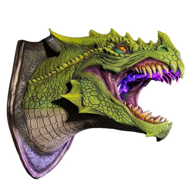 a green and purple dragon mask with its mouth open
