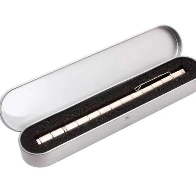 a pen in a silver box with a black cover